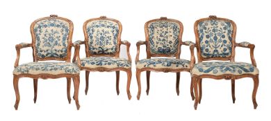 A set of four carved beech and needlework upholstered fauteuils in Louis XV style