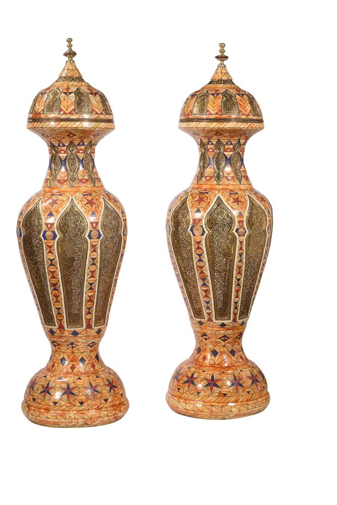 A pair of gilt metal and stained bone floor standing lanterns