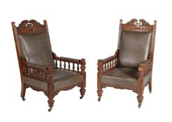 A pair of Victorian carved oak and leather upholstered armchairs