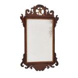 A George II mahogany and parcel gilt wall mirror