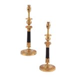 A pair of gilt and patinated metal candlesticks