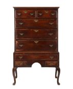 A George II oak and mahogany banded chest on stand