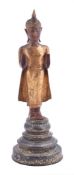 A Thai polychrome and parcel gilt wood figure of a buddha
