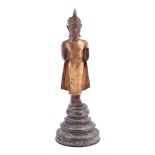 A Thai polychrome and parcel gilt wood figure of a buddha