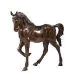 A bronzed metal figure of a horse