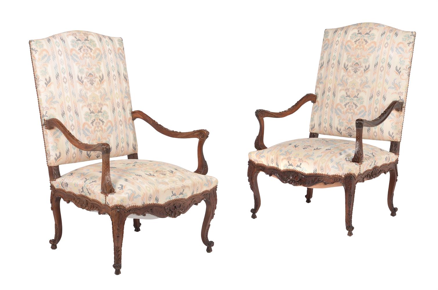 A pair of carved walnut armchairs in Louis XV style