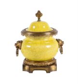 A Continental yellow crackled glazed pottery and gilt metal mounted urn and cover in the Chinese