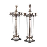 A pair of French patinated and gilt bronze five light candelabra in Neoclassical style