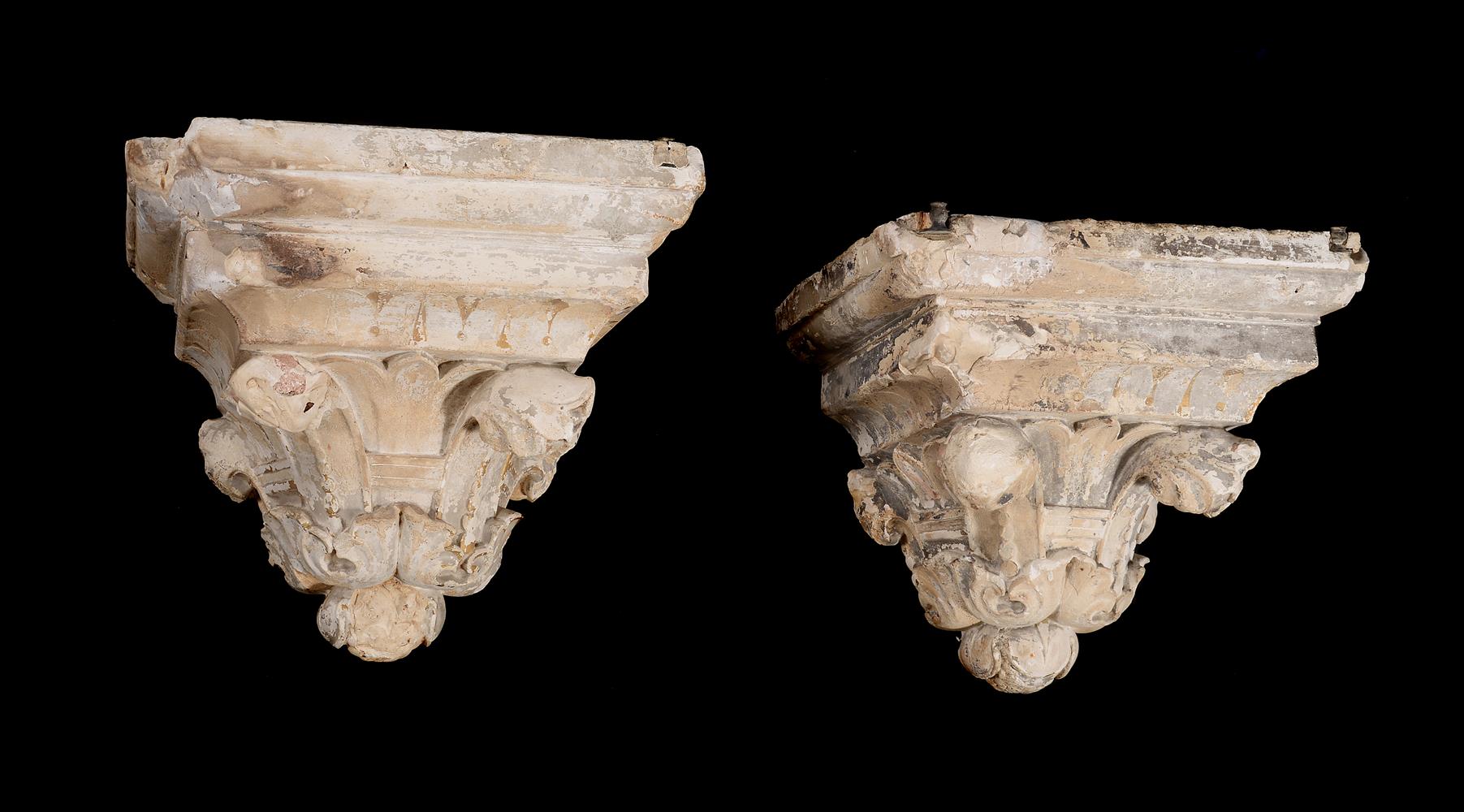 A pair of painted and parcel gilt composition architectural wall brackets