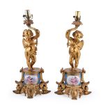 A pair of gilt metal and Sevres style porcelain mounted table lamps