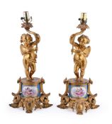 A pair of gilt metal and Sevres style porcelain mounted table lamps