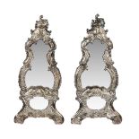 A pair of silver plated brass wall mirrors in Rococo style