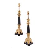 A pair of gilt and patinated metal candlesticks