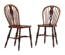 A pair of ash and elm wheel back chairs