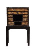 A black lacquer and parcel gilt japanned cabinet on stand