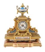A French gilt metal and Sevres style porcelain inset mantel clock