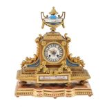 A French gilt metal and Sevres style porcelain inset mantel clock