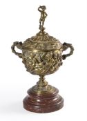A two handled gilt brass pedestal cup and cover