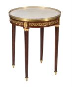 A French mahogany and gilt metal mounted gueridon table in Louis XVI style