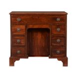 A mahogany kneehole desk in George III style