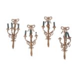 A set of four gilt metal wall appliques