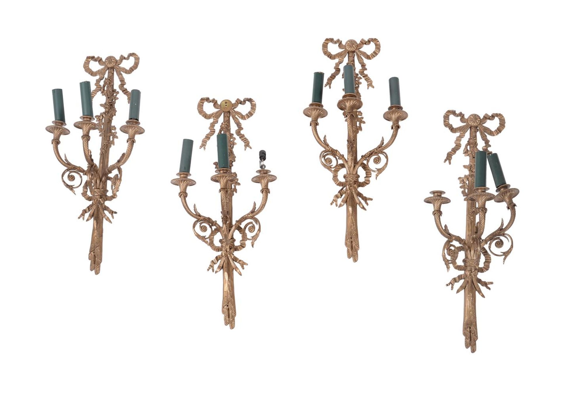 A set of four gilt metal wall appliques