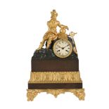 A Louis Philippe gilt and patinated bronze figural mantel clock