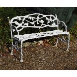 A white painted cast iron garden bench or 'Rustic Settee'