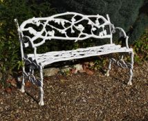 A white painted cast iron garden bench or 'Rustic Settee'