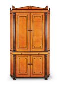 Y An Amboyna and ebonised cabinet in Regency style