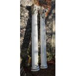 A pair of white painted fibreglass models of fluted columns