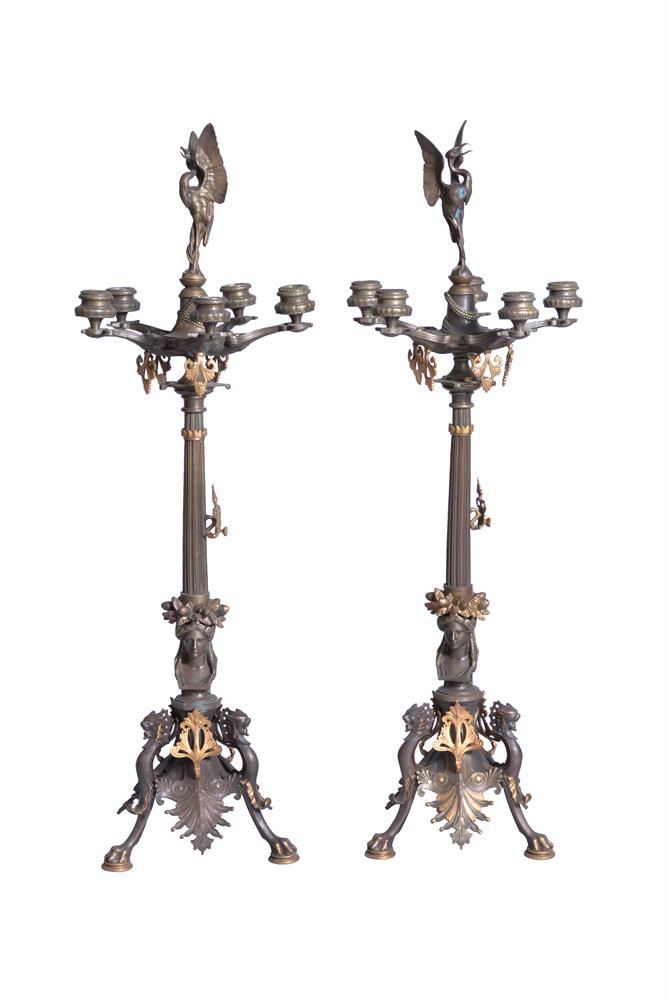 A pair of French patinated and gilt bronze five light candelabra in Neoclassical style