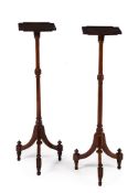 A pair of mahogany torcheres