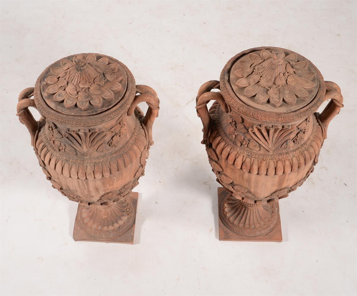 A pair of terracotta twin handled baluster urns and covers, in Italian Baroque taste - Image 2 of 2