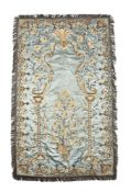 A blue silk and embroidered entre fenetre