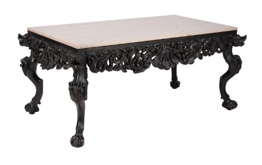 An ebonised, carved, and marble topped table