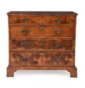 A George II walnut and ash crossbanded chest of drawers