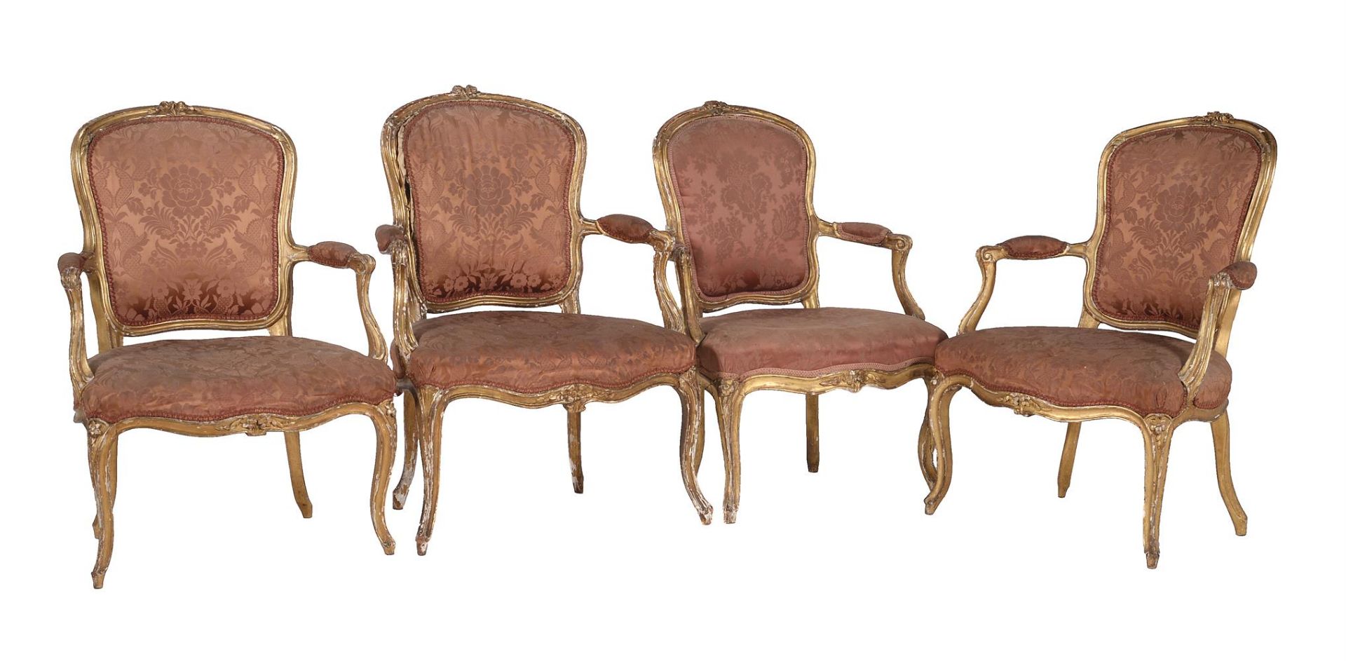 A harlequin set of four Louis XV giltwood and upholstered fauteuils