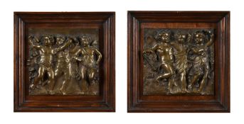 A pair of Italian bronze plaques of Bacchic putti