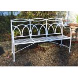 A white painted wrought iron garden bench