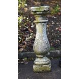 A carved limestone baluster plinth