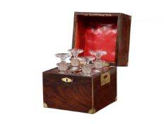A Victorian mahogany and brass bound campaign four decanter spirit set