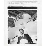 President John F. Kennedy with a scale model of the Apollo command module, Sept 1962