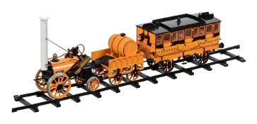 A Hornby live steam model of Stephenson's Rocket together with the matching passenger coach