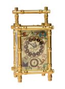 A FINE FRENCH GILT BAMBOO CASED REPEATING ALARM CARRIAGE CLOCK WITH AESTHETIC PORCELAIN PANELS