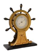 Y A VICTORIAN GILT BRASS AND EBONY ANEROID ‘SHIPS WHEEL’ MANTEL BAROMETER