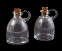 BACCARAT, A PAIR OF CLEAR GLASS BOTTLES