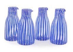A SET OF FOUR MURANO CLEAR AND BLUE VERTICAL STRIPE GLASS CARAFES