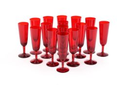 A SET OF SIXTEEN RUBY GLASS CHAMPAGNE FLUTES