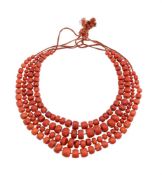 Y A FOUR ROW CORAL BEAD NECKLACEThe graduated coral beads on knotted strands to plaited backs